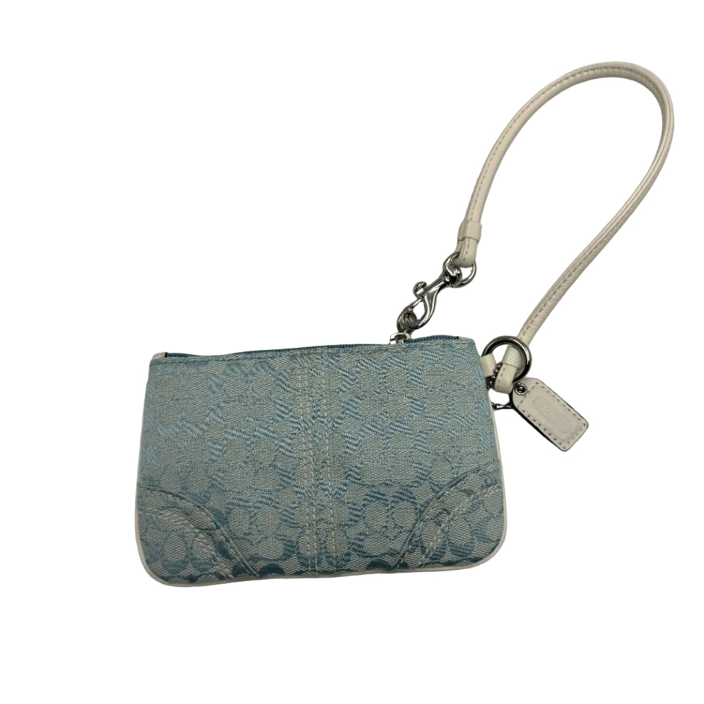 A light blue and white patterned wristlet clutch with a cream-colored wrist strap and silver-tone hardware, shown on a plain light gray background.