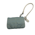 A light blue and white patterned wristlet clutch with a cream-colored wrist strap and silver-tone hardware, shown on a plain light gray background.