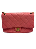 Shop the Chanel 19 small flap bag in coral pink quilted leather with multi-tone chain strap and leather-intertwined CC logo. 100% authentic pre-loved bag.