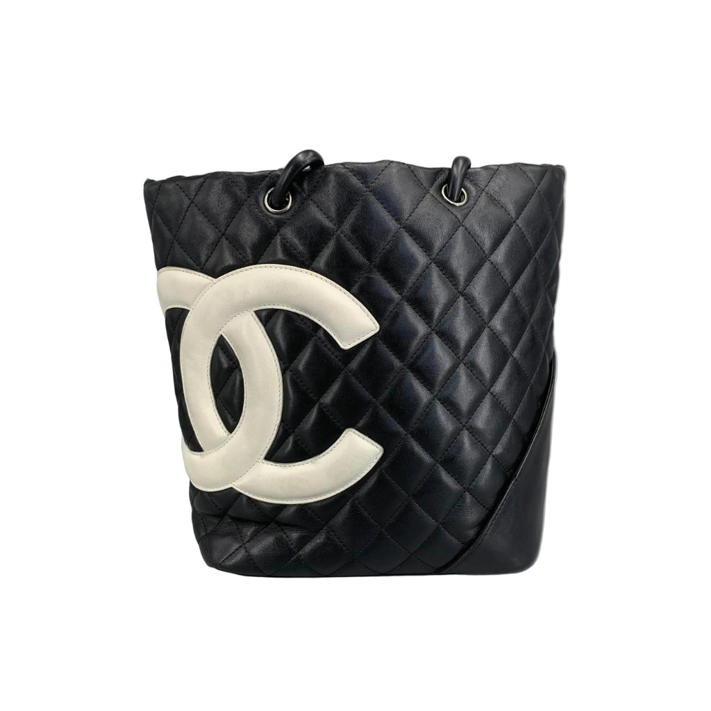 Front view of a Chanel Cambon Ligne Large Tote in black quilted leather with white CC logo on a white background.