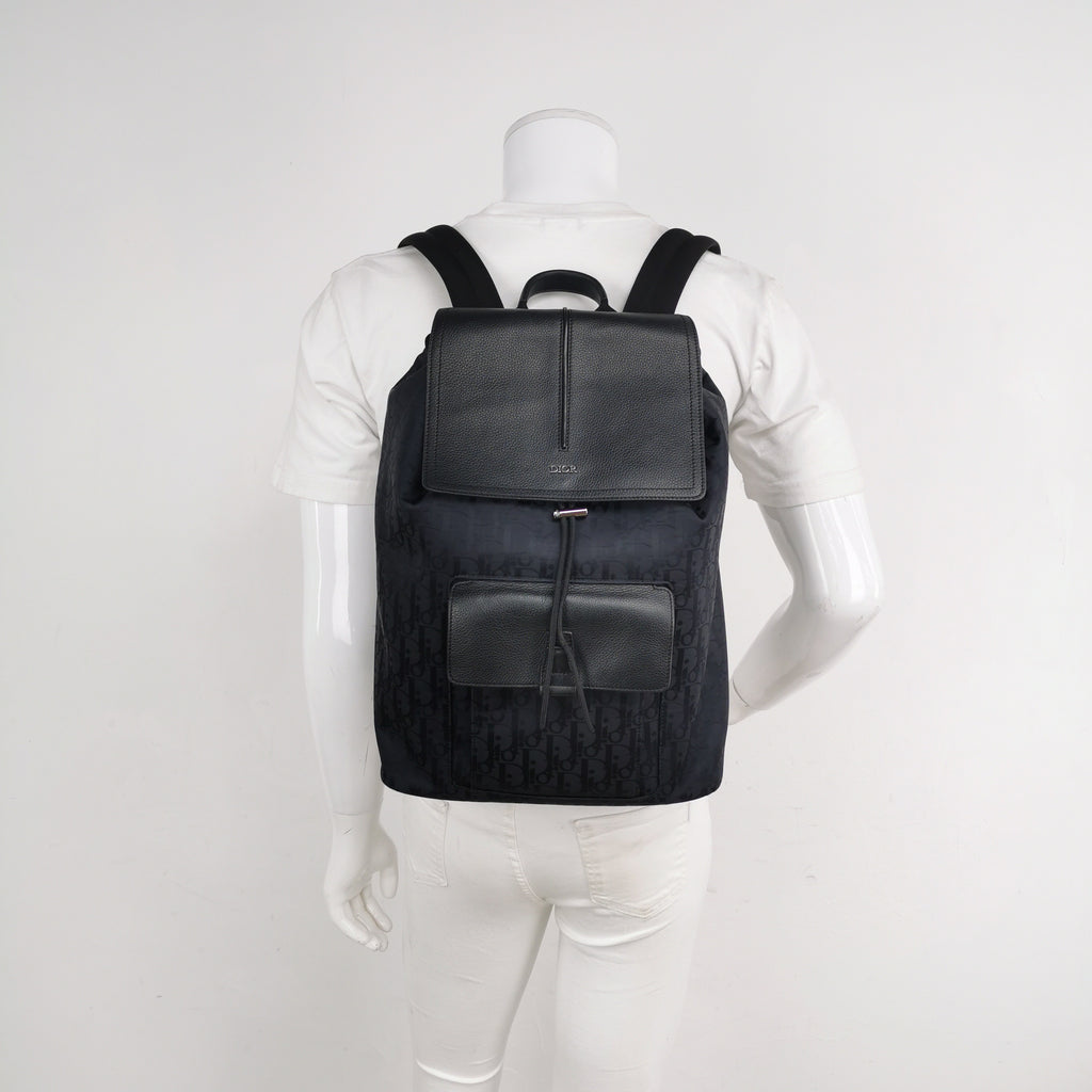 Black christian dior oblique canvas and leather backpack on a mannequin for size reference in excellent condition 
