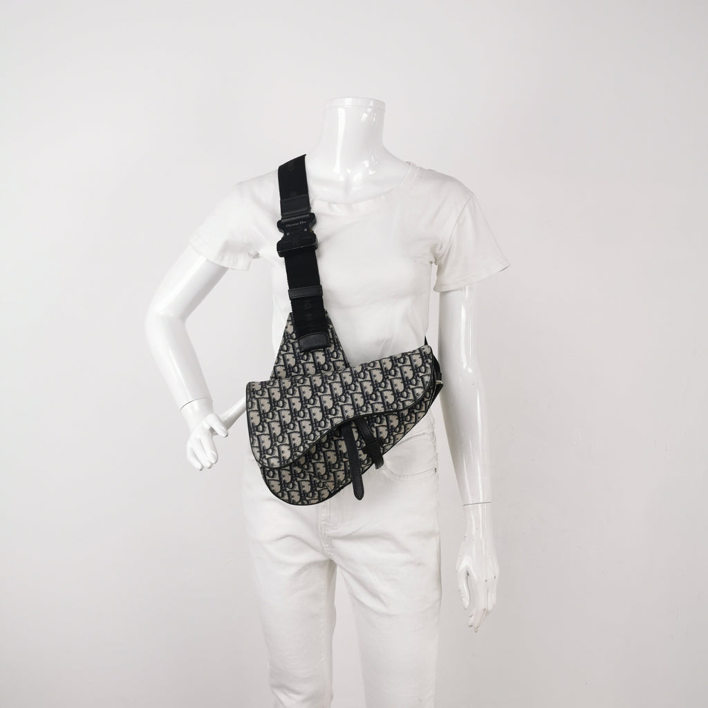 Mannequin wearing a preloved christian dior mens black crossbody bag in excellent condition 