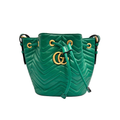 front view of green gucci marmont bucket bag with gold hardwware 