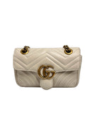 Authentic pre-owned Gucci GG Marmont matelassé small shoulder bag in white leather (22cm) featuring antique gold double G hardware and sliding chain strap.