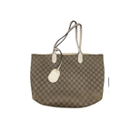 Brown patterned tote bag with beige handles on a white background