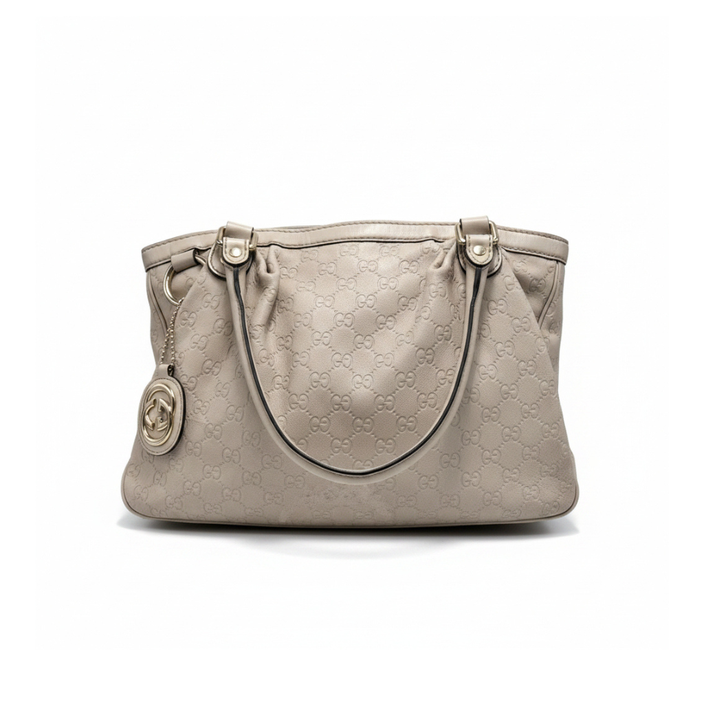 Beige handbag with a brand logo on a white background