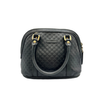 Black textured handbag with gold accents on a white background