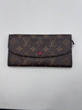 Authentic pre-owned Louis Vuitton Monogram Sarah long wallet in brown coated canvas featuring a distinctive red snap button closure.