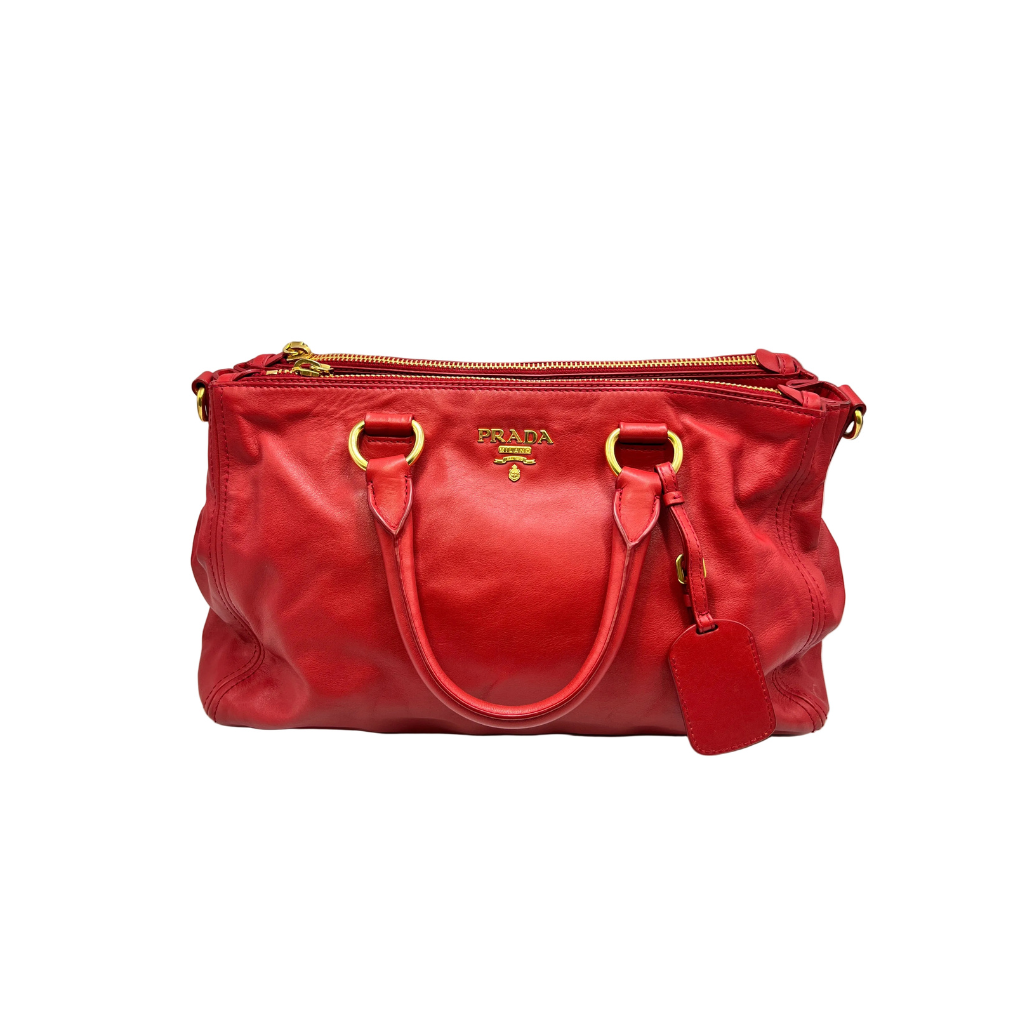 Red handbag with gold accents on a white background