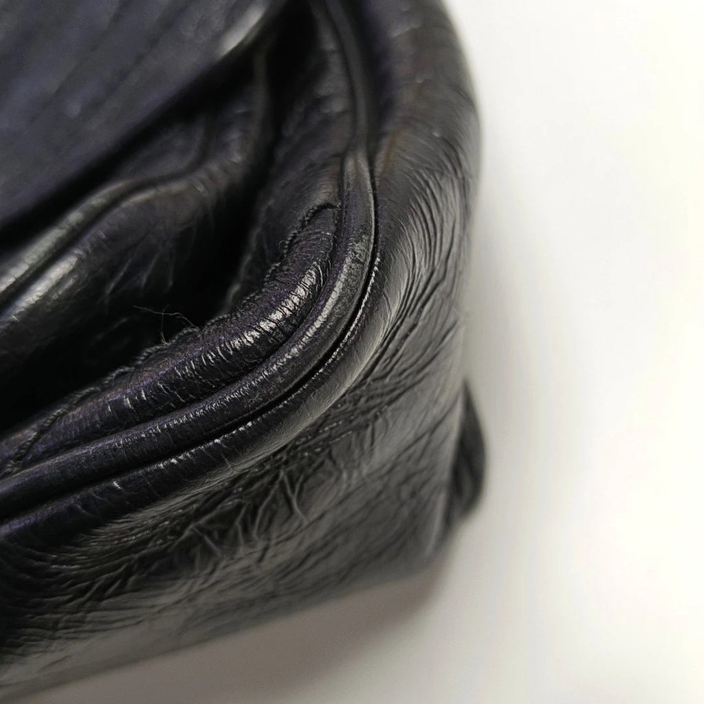 Close-up of black leather texture on niki medium bag