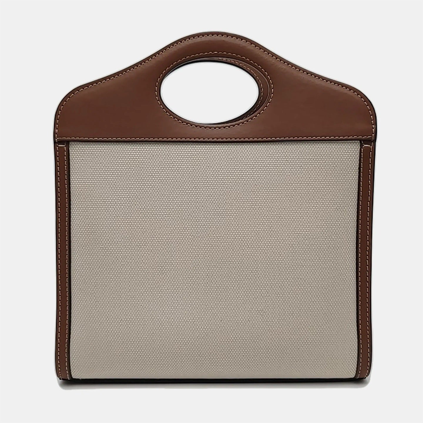 the back view of preowned burberry mini canvas pocket tophandle bag in excellent condition in brown leather and beige canvas
