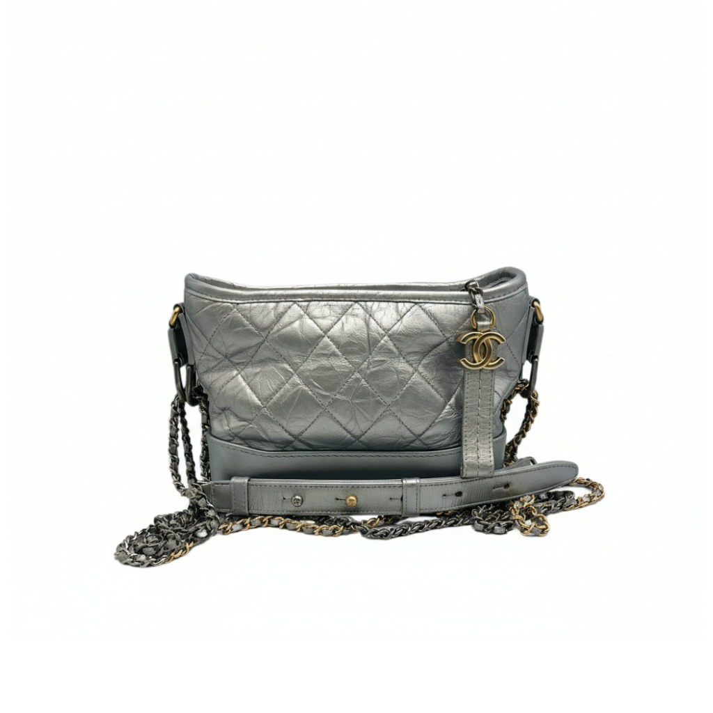 preloved chanel gabrilla hobo small handbag crossbody in silver metallic color with CC logo in gold the bag is in great condition 