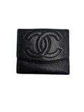 Front view of a vintage Chanel Timeless CC compact French purse wallet in black Caviar leather with stitched interlocking CC logo.