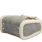 Gray quilted christian dior luxury handbag with white fur trim and gold accents for sale 