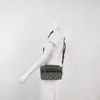 Mannequin wearing a black and white preowned christian dior oblique monogram crossbody waist bag with zipper closure