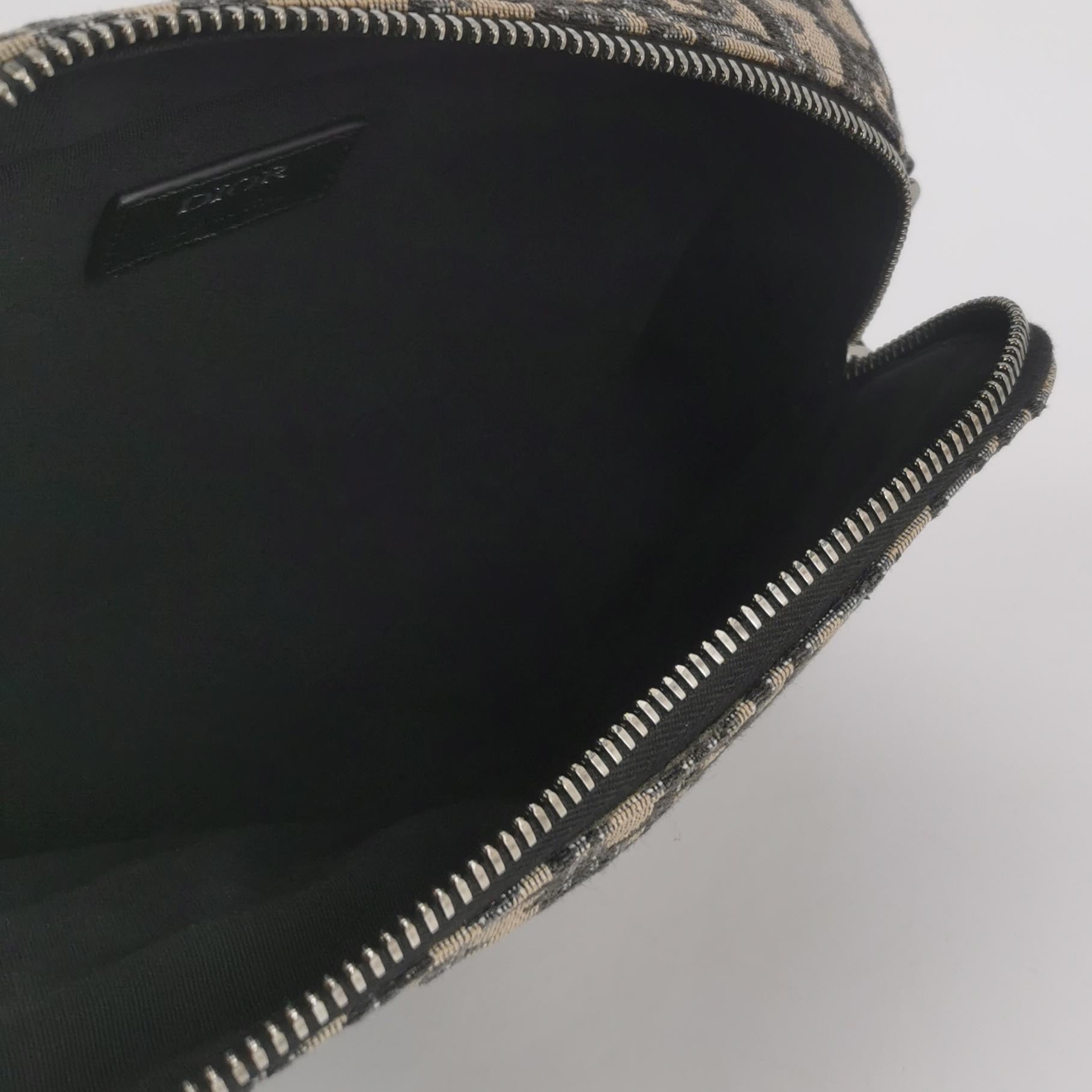 the inside of the christian dior oblique monogram bag with black interior and zip closure 