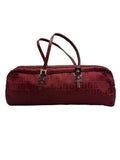 Front view of a vintage Fendi elongated cylindrical barrel shoulder bag in burgundy Zucca monogram canvas with thin leather straps.
