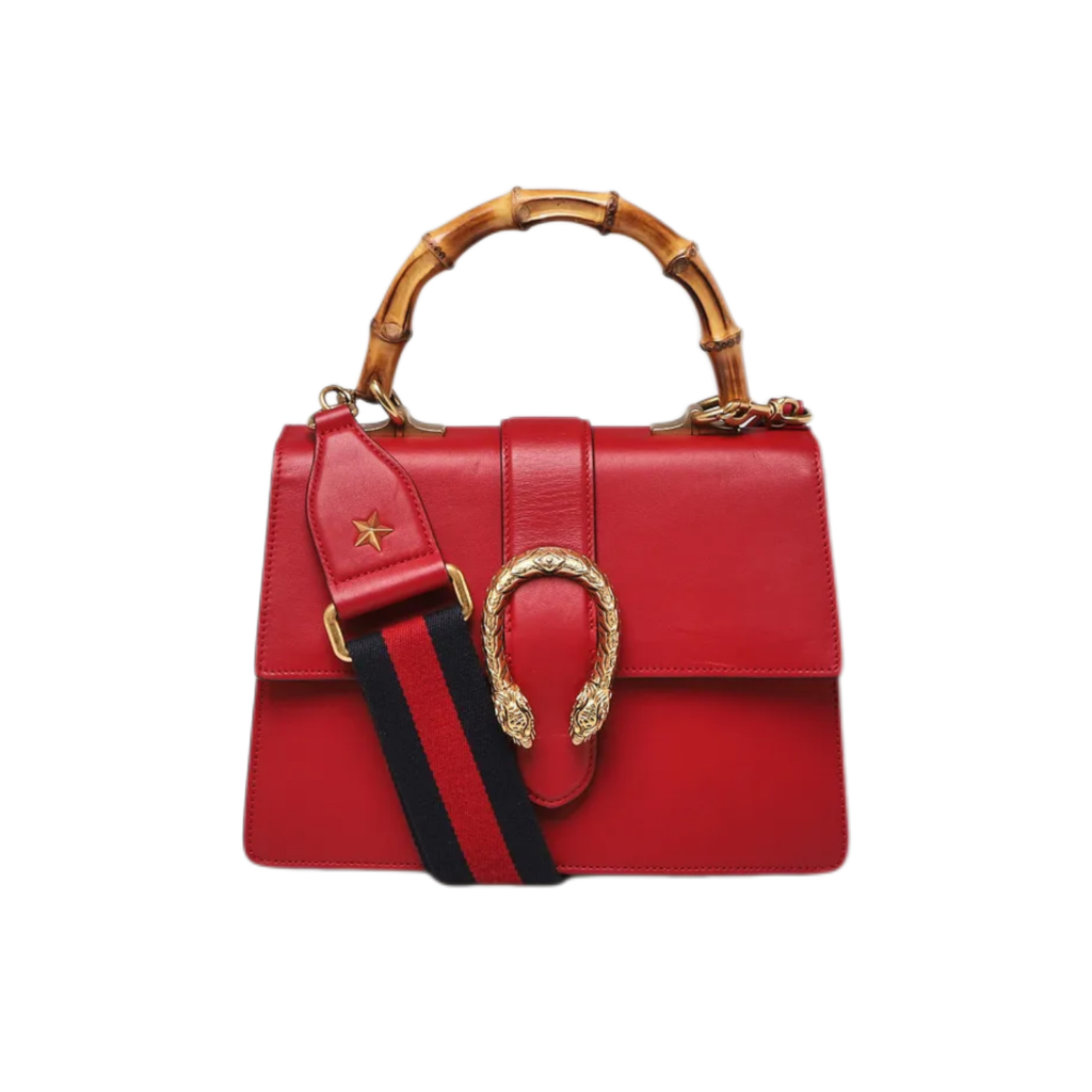 A red leather handbag with a bamboo top handle, a gold-tone horsebit clasp, and a green and red web stripe detail with a black center stripe, shown against a plain white background.