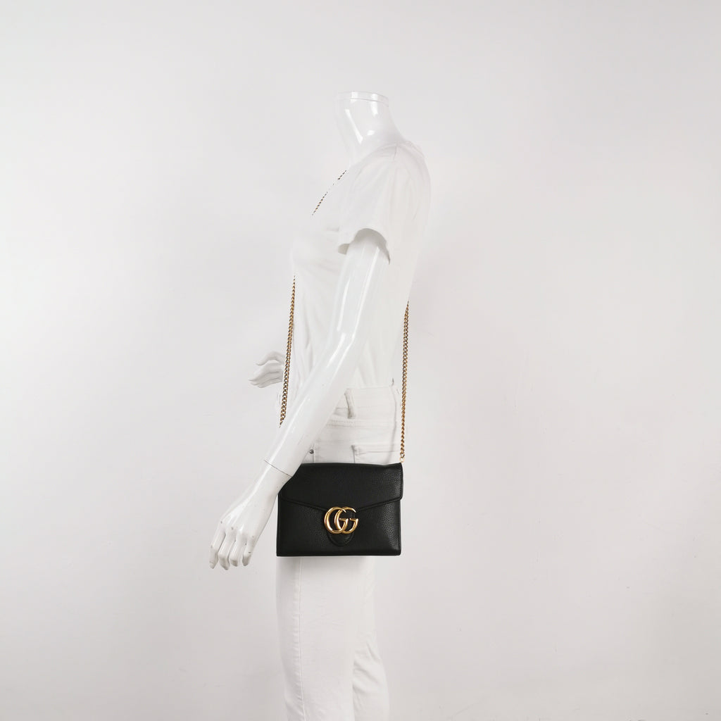 Black Gucci handbag on a mannequin for size reference