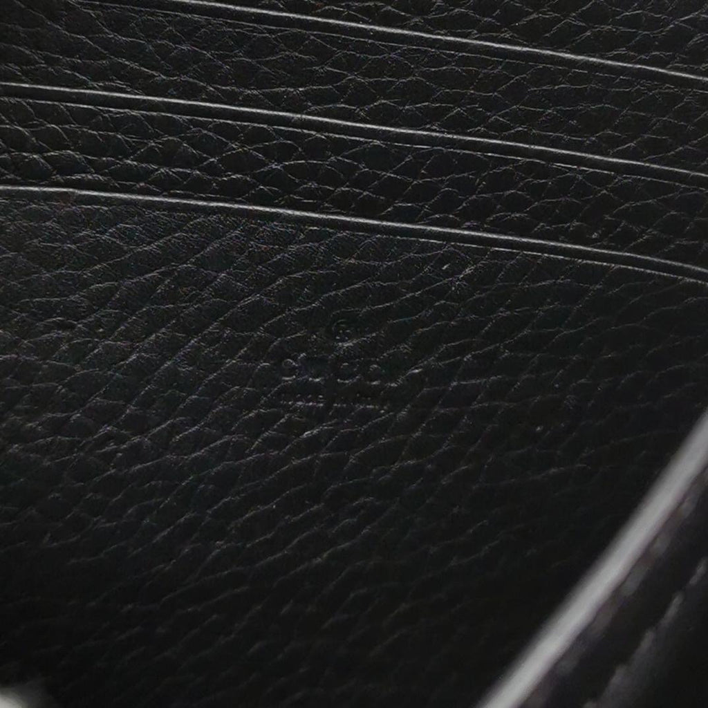 closeup look of the black leather with gucci logo engraved closeup look