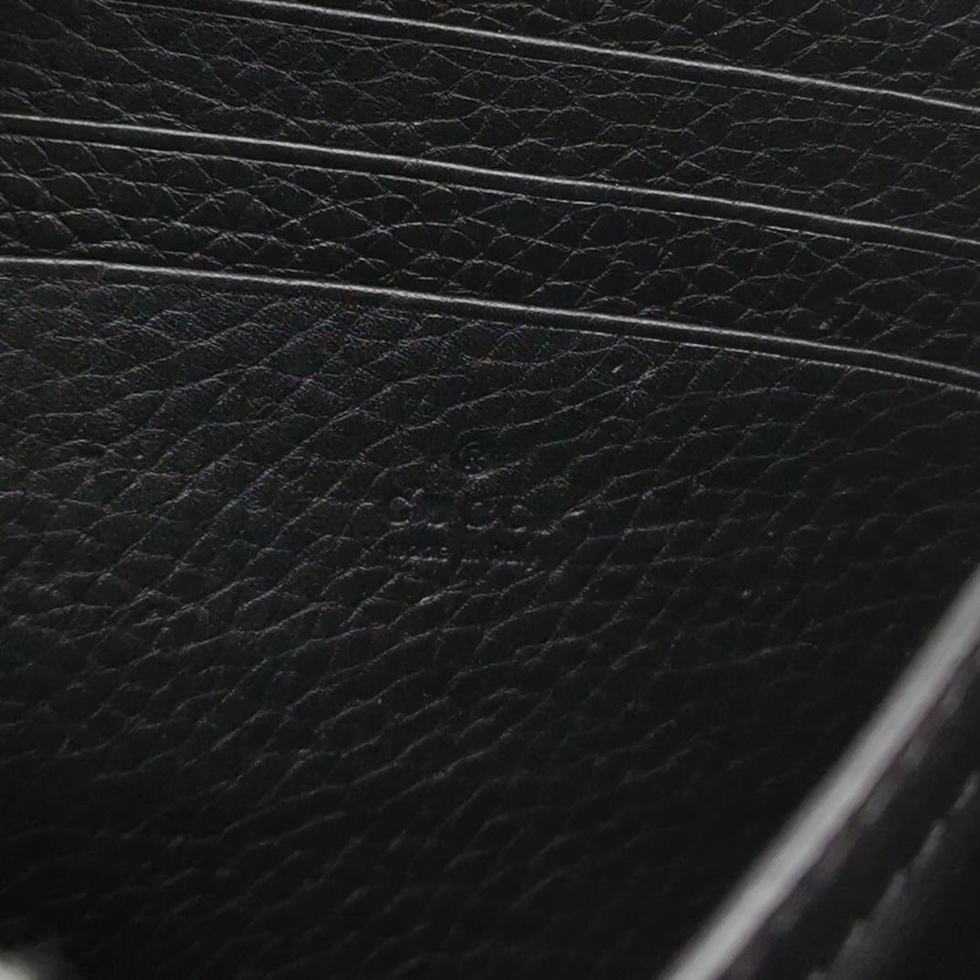 closeup look of the black leather with gucci logo engraved closeup look