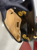 Close-up of gucci marmont handbag with gold hardware the inside is clean