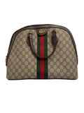 Front view of a Gucci Ophidia medium dome bag in GG Supreme canvas with brown leather handles, green and red Web stripe, and gold Double G hardware.