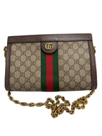 Front view of a Gucci Ophidia small shoulder bag in GG Supreme canvas with green and red Web stripe, brown leather trim, and gold chain strap.