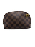 Front view of a Louis Vuitton Pochette Cosmetique pouch in Damier Ebene canvas featuring a brass D-ring and top zipper closure.