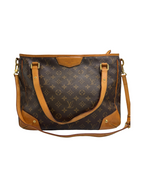Front view of a Louis Vuitton Estrela MM tote in Monogram canvas with honey vachetta leather handles, corner patches, and long shoulder strap.