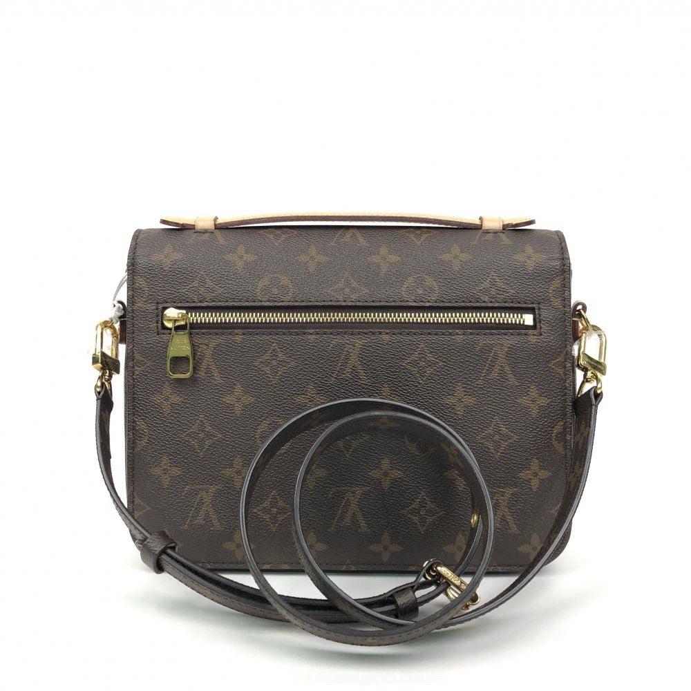 Back view of LV Pochette Métis highlighting the exterior zipped pocket and Monogram print.