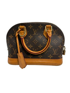 Louis Vuitton monogram canvas dome handbag with tan leather trim and handles, shown on a light gray background.