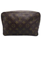 Front view of a vintage Louis Vuitton Trousse Toilette 28 cosmetic pouch in Monogram canvas.
