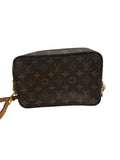 Front view of a Louis Vuitton Trousse Toilette 28 in Monogram canvas converted into a crossbody bag with a tan leather strap.