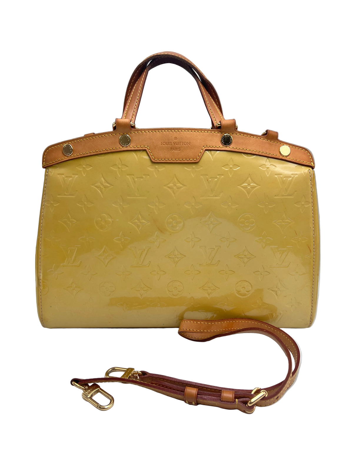 A Louis Vuitton Monogram Tote bag in glossy mustard yellow patent leather with tan leather trim and gold-tone hardware, shown with its detachable shoulder strap on a light gray background.