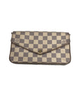 A Louis Vuitton clutch bag in the Damier Azur checkered canvas, featuring a beige and gray checkered pattern with a brown leather trim and a central snap button closure, set against a plain light gray background.