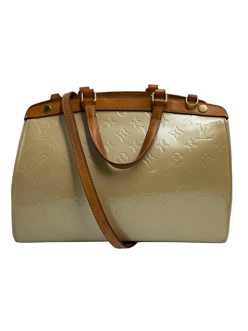 A Louis Vuitton monogrammed beige leather handbag with tan leather handles and shoulder strap, shown against a neutral gray background.