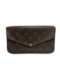 A Louis Vuitton monogram canvas clutch bag in dark brown with gold-tone hardware, photographed against a neutral light gray background.