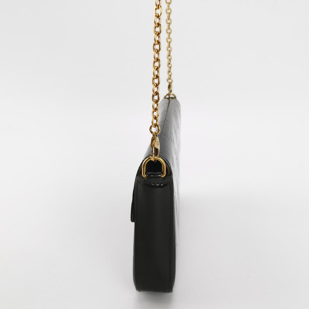 side view of black patent leather louis vuitton felicie pochette with shoulder strap