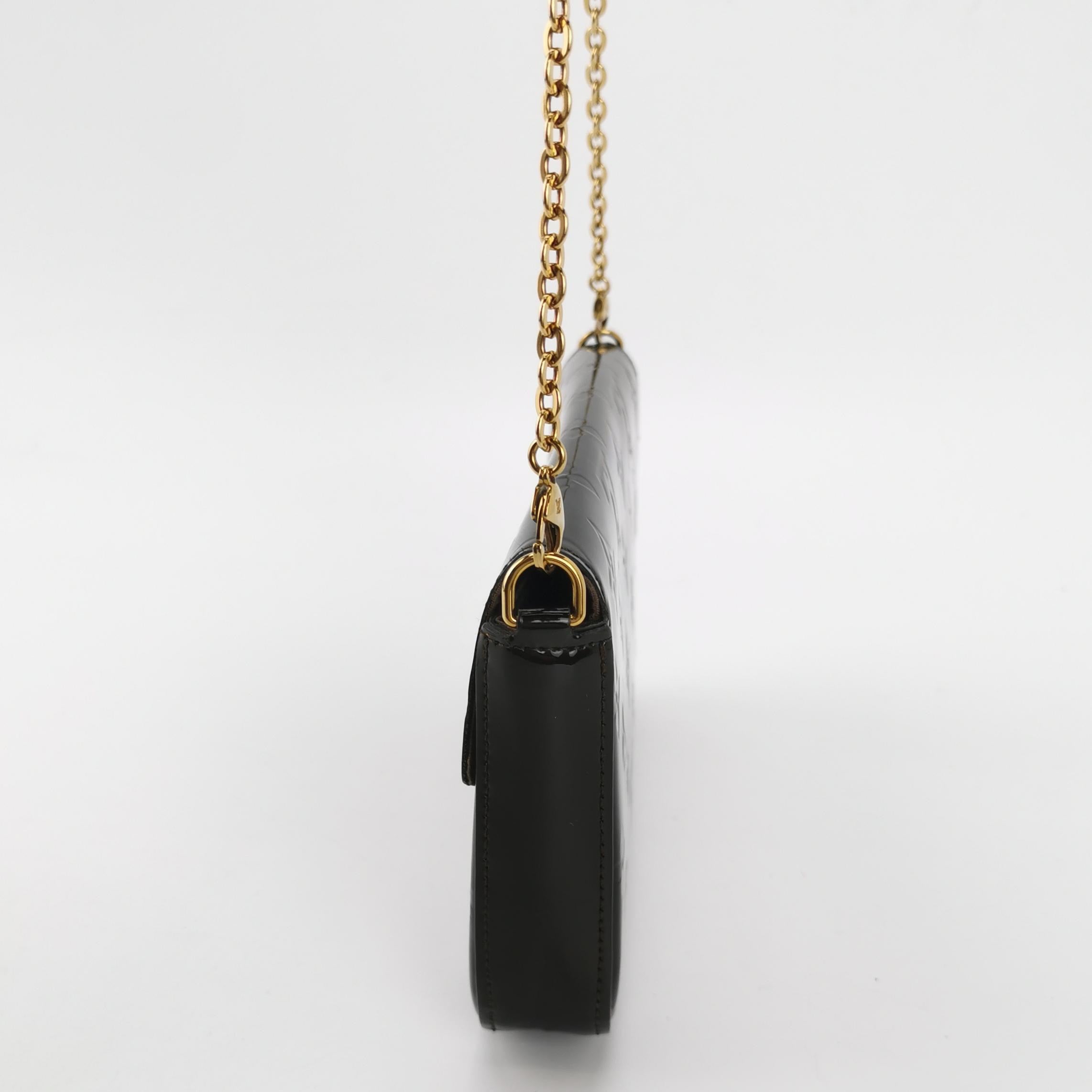 side view of black patent leather louis vuitton felicie pochette with shoulder strap