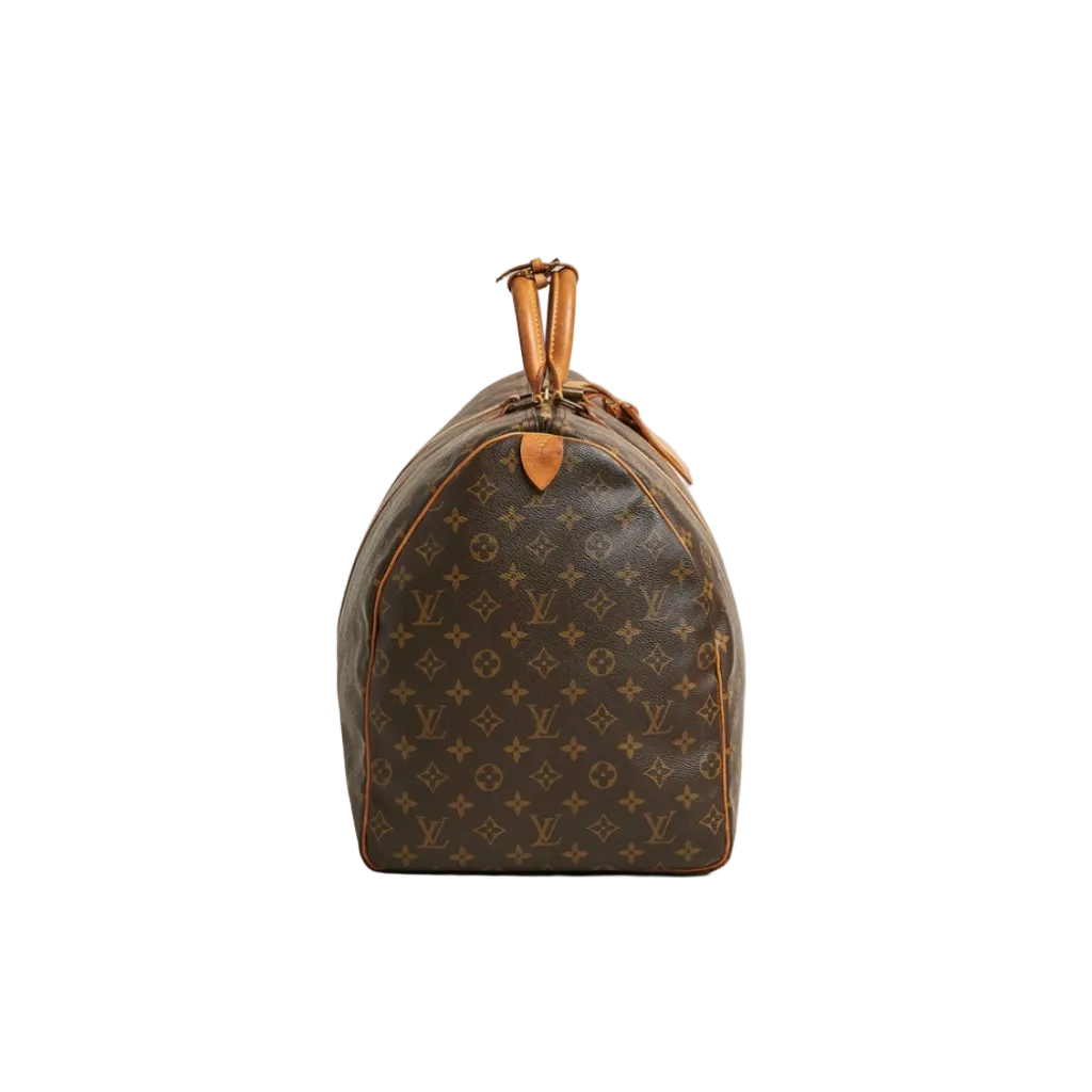 A Louis Vuitton monogram canvas duffel bag with tan leather trim and top handles, photographed against a neutral light gray background.