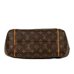A Louis Vuitton monogram canvas shoulder bag in dark brown with tan monogram motifs and thin tan piping along the edges, shown against a white background with a soft reflection.
