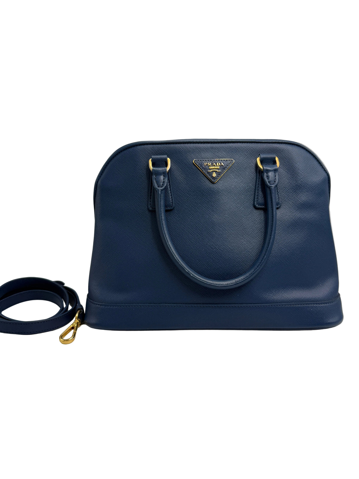 Front view of a Prada Promenade dome satchel in dark navy blue Saffiano leather with gold-tone hardware and matching adjustable strap.