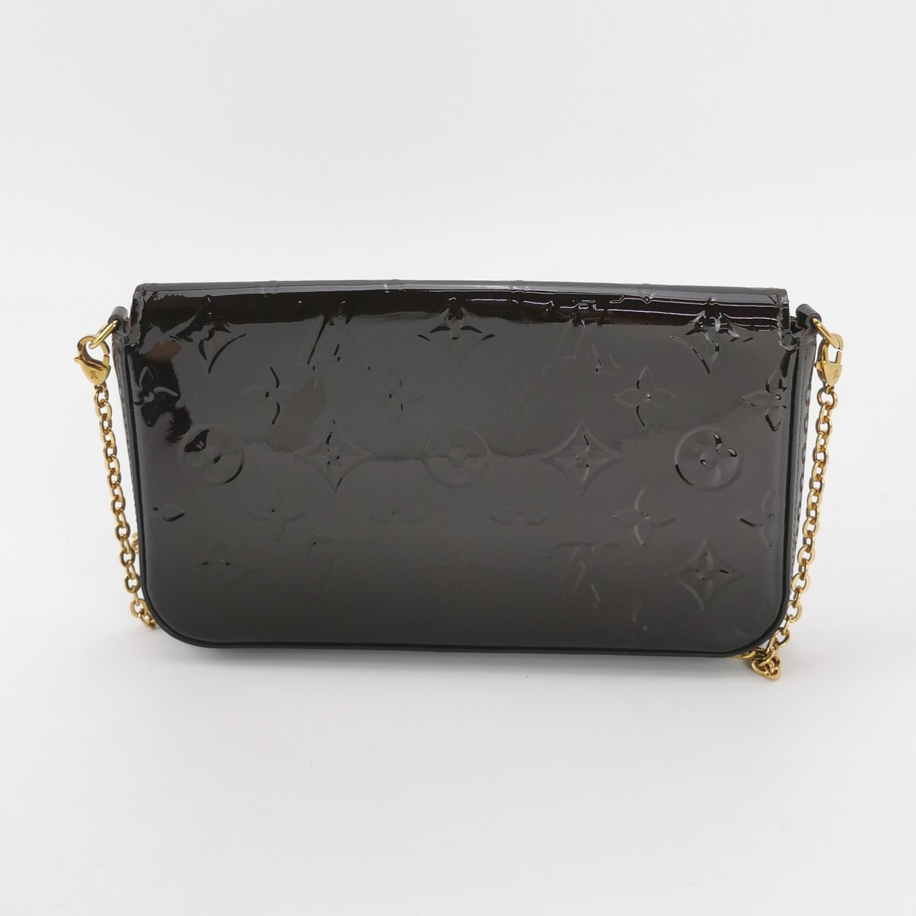 the back view of the preloved louis vuitton felicie pochette crossbody bag with gold chain strap in black patent leather monogram 
