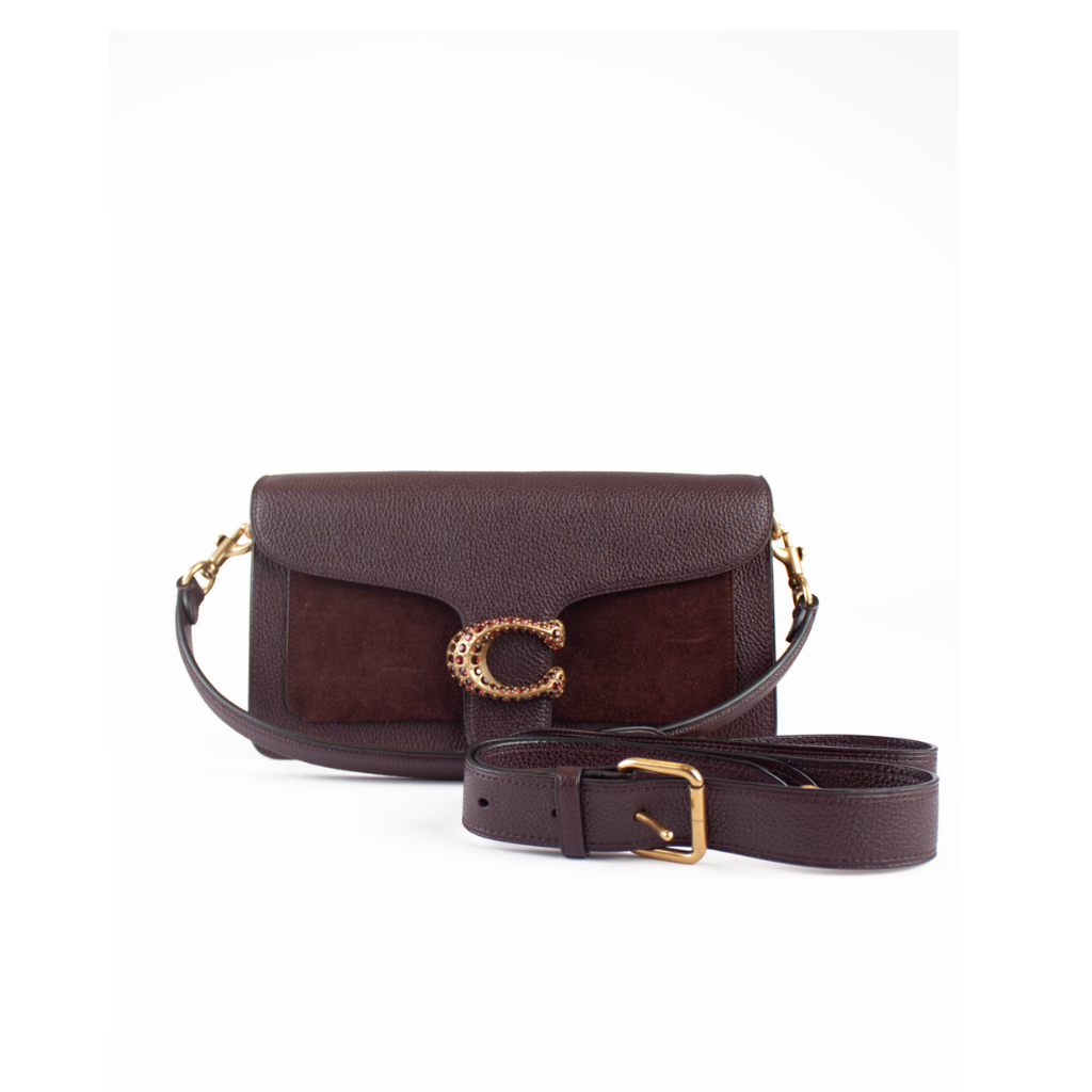 A dark brown leather shoulder bag with a textured flap, a suede-like center panel, and a prominent gold-tone 'C' logo clasp. A matching detachable brown leather strap with a gold buckle is displayed in front of the bag against a plain white background.