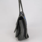 Grey saint laurent handbag with a chain strap on a light gray background